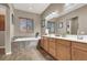 Bright bathroom featuring a double vanity, bathtub, and modern fixtures at 7420 Zonal Ave, Las Vegas, NV 89131