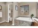 Bright bathroom features a tub with tile surround, and tile floors at 7420 Zonal Ave, Las Vegas, NV 89131