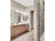 Modern bathroom featuring wood-style tile floors, double sinks and glass shower at 7420 Zonal Ave, Las Vegas, NV 89131
