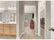 Bright bathroom featuring a double vanity, a doorway to the bathroom and closet at 7420 Zonal Ave, Las Vegas, NV 89131