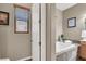 Bathroom featuring a tub with tile surround, a window, and a door at 7420 Zonal Ave, Las Vegas, NV 89131