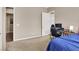 Cozy bedroom space featuring neutral walls, plush carpet, and a comfortable gaming area, adjacent to an open doorway at 7420 Zonal Ave, Las Vegas, NV 89131