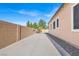 A long driveway offers ample parking and leads to a secure backyard, surrounded by a brick wall at 7420 Zonal Ave, Las Vegas, NV 89131