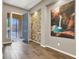 Inviting entryway with a brick accent wall, tile flooring, natural light, and modern decor at 7420 Zonal Ave, Las Vegas, NV 89131