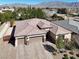 Beautiful home showcasing a three-car garage, tile roof, and desert landscaping at 7420 Zonal Ave, Las Vegas, NV 89131
