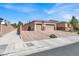 Charming home exterior with a three-car garage, paved driveway, and landscaped front yard at 7420 Zonal Ave, Las Vegas, NV 89131
