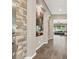 Elegant foyer features stone accent walls, wood floors, and view into a living room, creating a warm and inviting entrance at 7420 Zonal Ave, Las Vegas, NV 89131