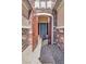Inviting entryway featuring a decorative metal gate and a blue front door, complemented by stone accents and brick walkway at 7420 Zonal Ave, Las Vegas, NV 89131