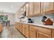 Well-lit kitchen with ample cabinet space, stainless steel microwave and gray backsplash at 7420 Zonal Ave, Las Vegas, NV 89131