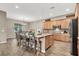 Spacious kitchen with an island, wooden cabinets, modern appliances, a dining table and chairs at 7420 Zonal Ave, Las Vegas, NV 89131
