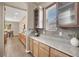 Bright kitchen featuring wood cabinets, granite countertops, decorative backsplash, and modern appliances at 7420 Zonal Ave, Las Vegas, NV 89131