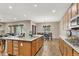 Modern kitchen featuring an island, stainless steel appliances, and a breakfast bar overlooking the dining area at 7420 Zonal Ave, Las Vegas, NV 89131
