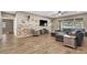 Spacious living room featuring wood floors, a stone accent wall, and a comfortable seating area at 7420 Zonal Ave, Las Vegas, NV 89131
