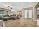 Spacious living room with hardwood floors, neutral walls, and large sectional sofa with a fan in the ceiling at 7420 Zonal Ave, Las Vegas, NV 89131