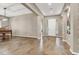 Open-concept living room with wood-look tile, neutral walls, a piano, and a bright white front door at 7420 Zonal Ave, Las Vegas, NV 89131