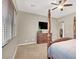 Spacious main bedroom features a four poster bed, carpet, TV, and a dresser at 7420 Zonal Ave, Las Vegas, NV 89131