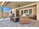 Inviting outdoor patio with comfortable seating, a fire pit, and a ceiling fan, perfect for entertaining and relaxing at 7420 Zonal Ave, Las Vegas, NV 89131