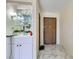 Entryway with marble floors, a mirrored wet bar, and apartment door at 745 N Royal Crest Cir # 158, Las Vegas, NV 89169