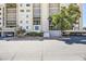 Condo building exterior shows well maintained facade, mature landscaping and ample parking available for residents and guests at 745 N Royal Crest Cir # 158, Las Vegas, NV 89169