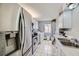 Galley kitchen featuring stainless steel appliances and in unit laundry at 745 N Royal Crest Cir # 158, Las Vegas, NV 89169