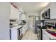 Galley kitchen featuring white cabinets, stainless steel appliances, and marble countertops at 745 N Royal Crest Cir # 158, Las Vegas, NV 89169