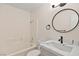 Bathroom featuring a tub, modern vanity, granite countertops, and updated fixtures at 7554 Violet Vista Ave # 201, Las Vegas, NV 89130