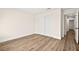 Bedroom featuring wood-look floors and a closet with sliding doors for optimal storage space at 7554 Violet Vista Ave # 201, Las Vegas, NV 89130