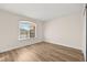 Bedroom with a window offering natural lighting and wood-look flooring, creating a modern appeal at 7554 Violet Vista Ave # 201, Las Vegas, NV 89130