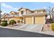 Charming townhome showcases a two-car garage, mature landscaping, and a neutral color palette at 7554 Violet Vista Ave # 201, Las Vegas, NV 89130