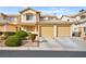 Inviting two-story home with a well-maintained yard, double garage, and charming architectural details at 7554 Violet Vista Ave # 201, Las Vegas, NV 89130