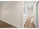 Hallway with a closet featuring mirrored doors and leading into another room with natural light at 7554 Violet Vista Ave # 201, Las Vegas, NV 89130