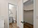Hallway showcasing a view to the bathroom with a glass shower and a closet with a hanging rod at 7554 Violet Vista Ave # 201, Las Vegas, NV 89130