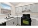 Updated kitchen with new cabinets, countertops, stainless steel appliances, and wood flooring at 7554 Violet Vista Ave # 201, Las Vegas, NV 89130