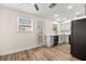 Bright kitchen features modern appliances, white cabinets, wood flooring, and a door leading to the outside at 7554 Violet Vista Ave # 201, Las Vegas, NV 89130