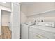 A dedicated laundry room with a washer, dryer, and shelving at 7554 Violet Vista Ave # 201, Las Vegas, NV 89130