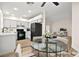 Open-concept kitchen and living area featuring modern white cabinets, black appliances, and stylish furnishings at 7554 Violet Vista Ave # 201, Las Vegas, NV 89130