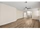 Spacious main bedroom featuring wood-look floors, ceiling fan, and ensuite bathroom entrance at 7554 Violet Vista Ave # 201, Las Vegas, NV 89130