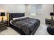 Bright bedroom features a large bed with end tables and sleek black and gold accents at 8000 Clock Tower Ct, Las Vegas, NV 89117