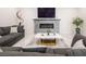 Contemporary living room with gray sectional, textured wall, fireplace, and marble coffee table at 8000 Clock Tower Ct, Las Vegas, NV 89117