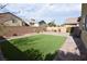 Well-maintained backyard with lush artificial turf and brick perimeter at 8084 Bosco Bay Ave, Las Vegas, NV 89113