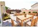 Outdoor dining and lounge area with wooden furniture and decorative plants at 8084 Bosco Bay Ave, Las Vegas, NV 89113