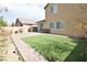 Spacious backyard with artificial turf and stone-paved patio area at 8084 Bosco Bay Ave, Las Vegas, NV 89113