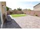 Large stone-paved backyard with four chairs on the patio at 8084 Bosco Bay Ave, Las Vegas, NV 89113
