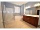 Bathroom featuring double sinks and a tub with shower at 8084 Bosco Bay Ave, Las Vegas, NV 89113