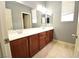 Bathroom boasts a large vanity with double sinks and wood cabinets at 8084 Bosco Bay Ave, Las Vegas, NV 89113