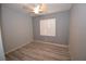 Bedroom with modern ceiling fan, neutral walls, and hardwood floors. Window with shutters at 8084 Bosco Bay Ave, Las Vegas, NV 89113