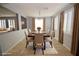 Elegant dining room featuring a chandelier, large window, and seating for six at 8084 Bosco Bay Ave, Las Vegas, NV 89113