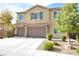 Inviting two-story home featuring a neutral color palette, shutters, attached two-car garage and landscaped front yard at 8084 Bosco Bay Ave, Las Vegas, NV 89113