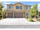 Inviting two-story home featuring a neutral color palette, shutters, attached two-car garage and landscaped front yard at 8084 Bosco Bay Ave, Las Vegas, NV 89113