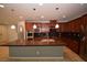 Open kitchen with stainless steel appliances, dark granite counters, and a large island at 8084 Bosco Bay Ave, Las Vegas, NV 89113